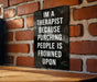 a sign that says i'm a therapist because punching people is