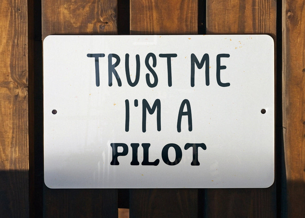 a white sign that says trust me i'm a pilot