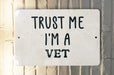 a white sign that says trust me i'm a vet