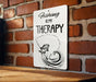 a sign on a brick wall that says fishing is my therapy