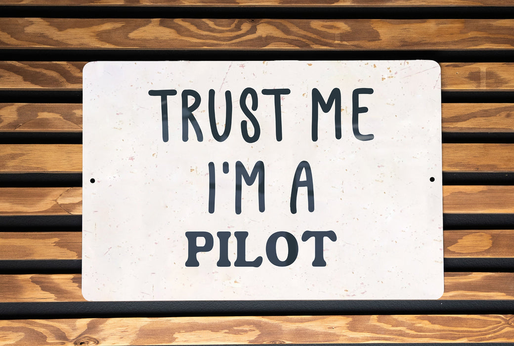 a white sign that says trust me i'm a pilot