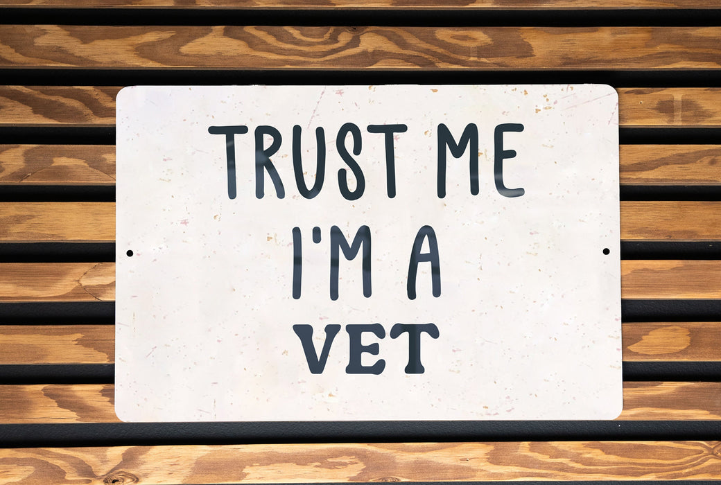 a white sign that says trust me i'm a vet