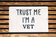 a white sign that says trust me i'm a vet