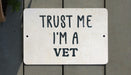 a white sign that says trust me i'm a vet
