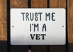 a white sign that says trust me i'm a vet