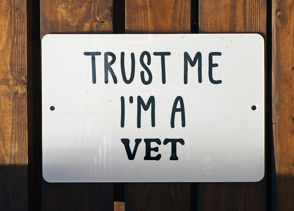 a white sign that says trust me i'm a vet