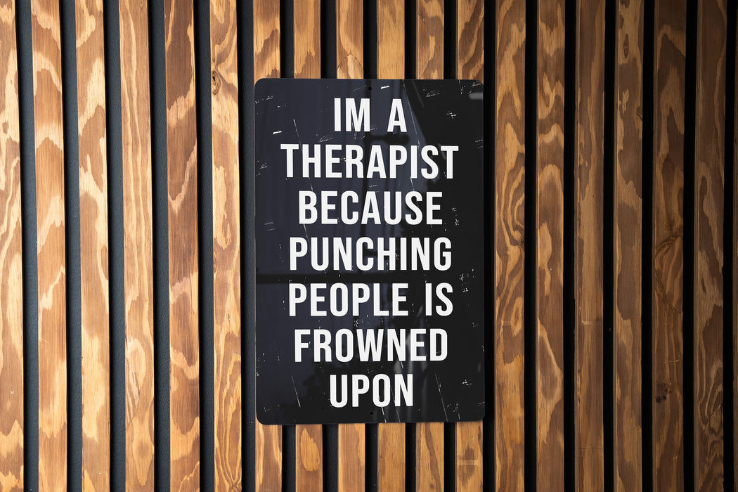 a sign on a wooden wall that says i'm a therapist