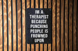 a sign on a wooden wall that says i'm a therapist