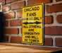 a yellow chicago fans parking only sign on a brick wall