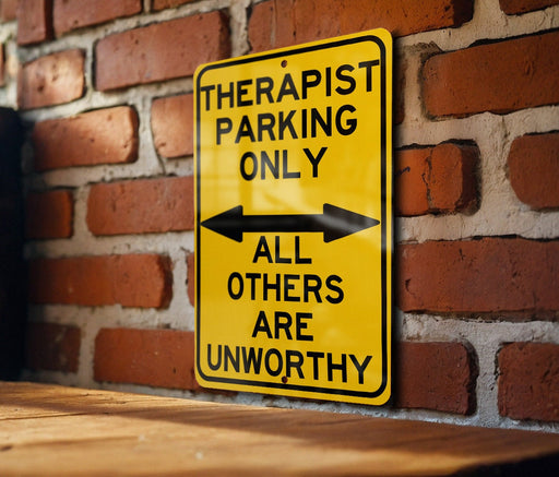 a yellow and black sign on a brick wall