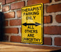 a yellow and black sign on a brick wall