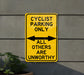 a yellow sign that says cyclist parking only all others are unworthyly