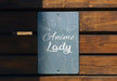 a sign on a wooden bench that says animee lady