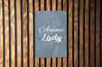 a sign on a wooden wall that says anime lady