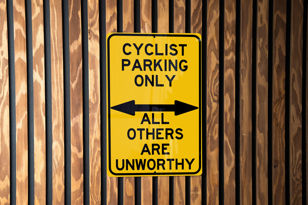 a yellow and black sign on a wooden wall