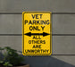 a yellow sign that says vet parking only all others are unworthyly