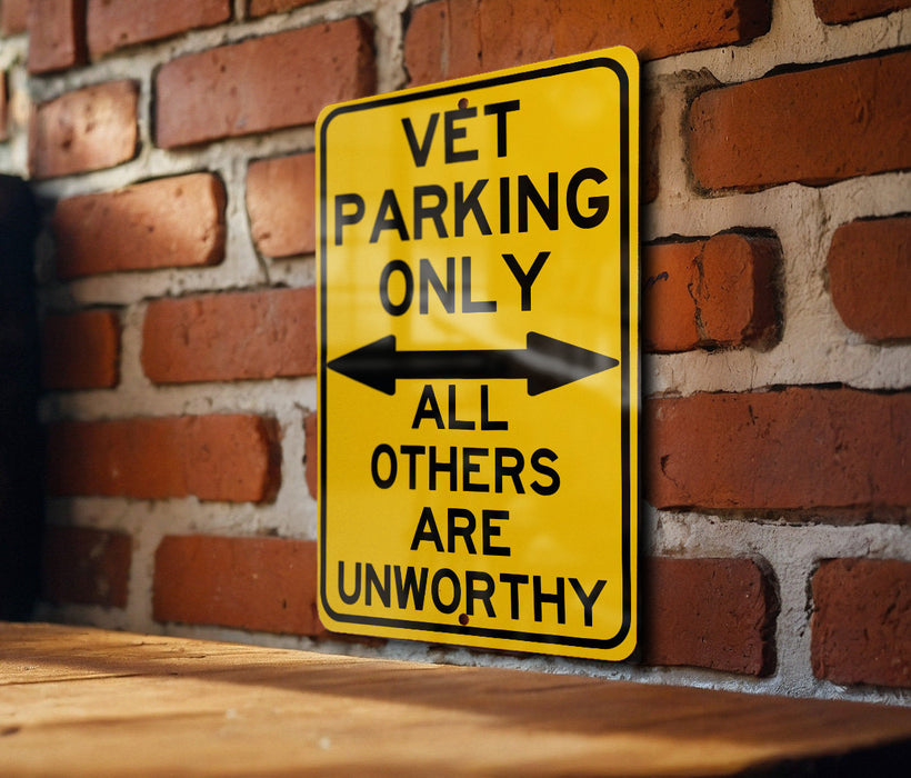 a yellow sign on a brick wall that says vet parking only all others are un