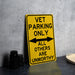 a yellow sign that says vet parking only all others are unworthyly