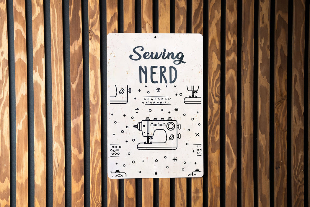 a sign on a wooden wall that says sewing nerd