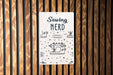 a sign on a wooden wall that says sewing nerd