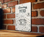 a sign on a brick wall that says sewing nerd