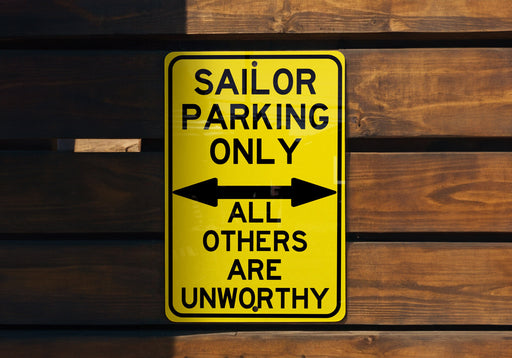 a yellow sign that says sailor parking only all others are unworthyly
