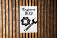 a sign on a wooden wall that says engineer nerd