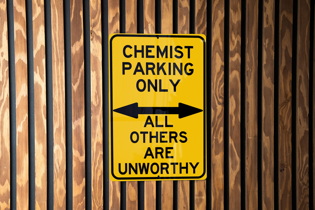 a yellow and black sign on a wooden wall