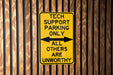 a yellow sign that says tech support parking only all others are unworthyly