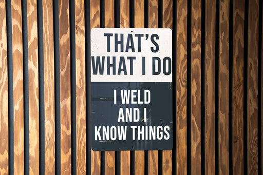 a sign on a wooden wall that says, that's what i do i