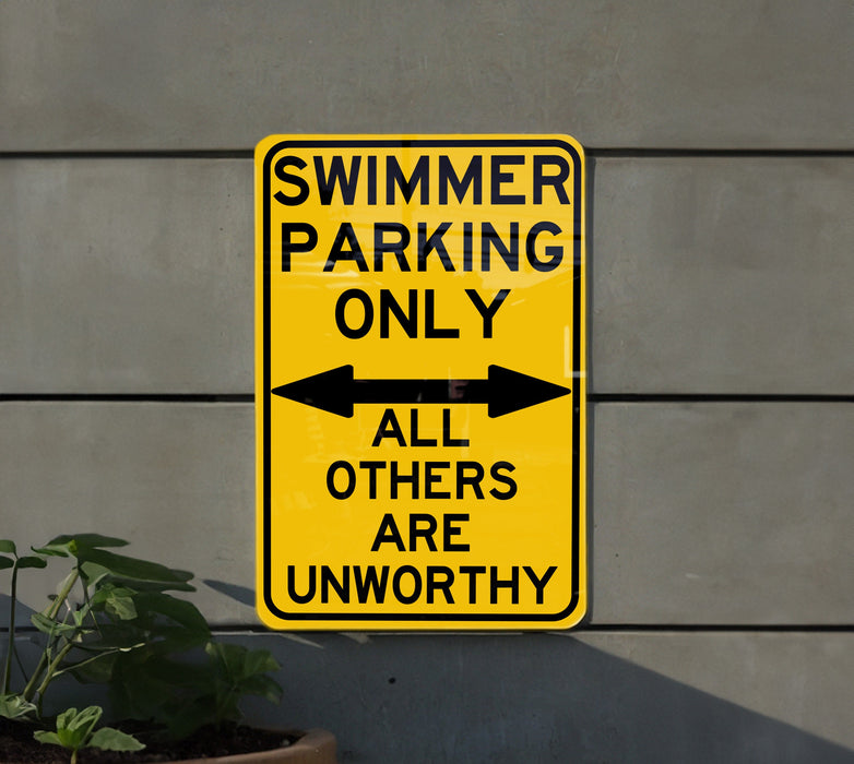 a yellow swimming only sign hanging on the side of a building