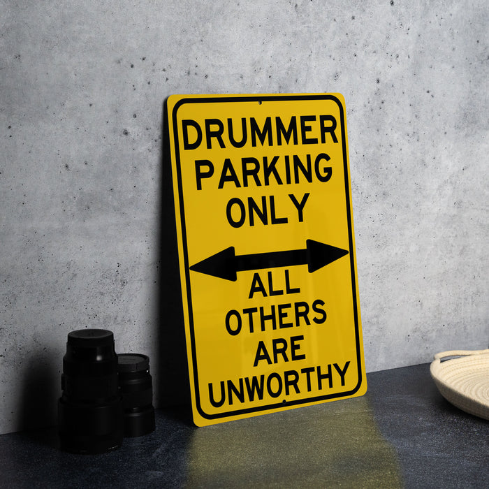 a yellow sign that says drummer parking only all others are unworthyly