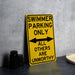 a yellow swimming only sign sitting on top of a table