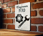 a sign on a brick wall that says engineer nerd