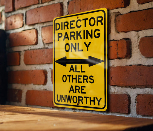 a yellow sign on a brick wall that says director parking only all others are un