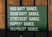 a green sign that says bad day? dance good day? dance stressed?