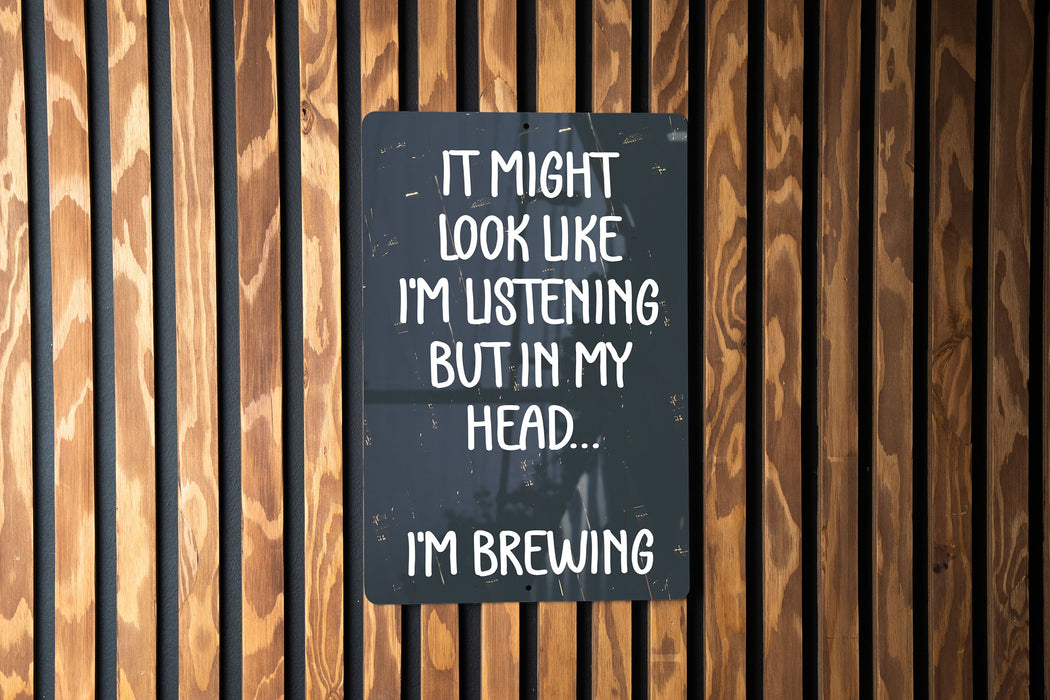 a sign on a wooden wall that says it might look like i'm listening