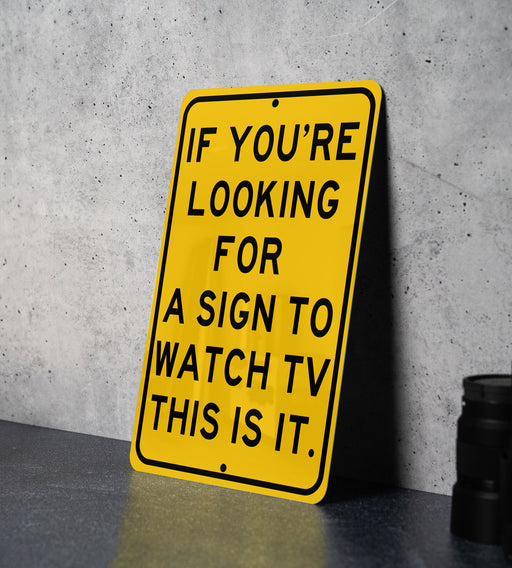 a yellow sign that says if you're looking for a sign to watch tv
