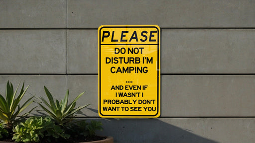 a yellow sign that says please don't disturb i'm camping