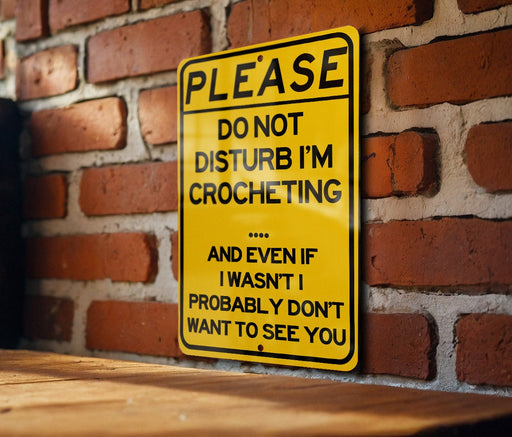 a yellow sign on a brick wall that says please don't disturb i '