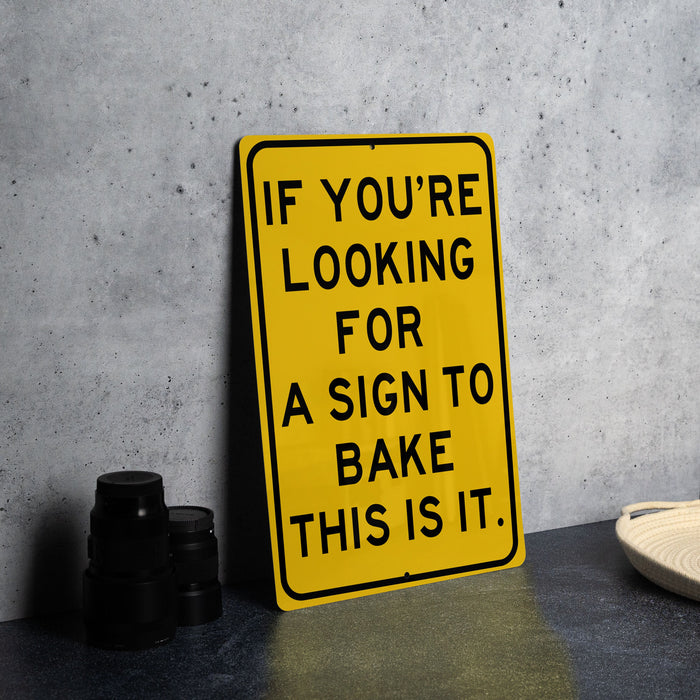 a yellow sign that says if you're looking for a sign to bake