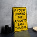 a yellow sign that says if you're looking for a sign to bake