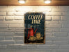 a coffee time sign on a brick wall