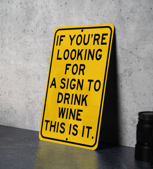 a yellow sign that says if you're looking for a sign to drink wine