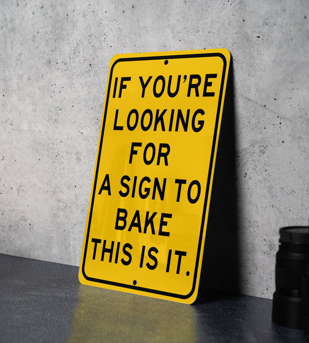 a yellow sign that says if you're looking for a sign to bake