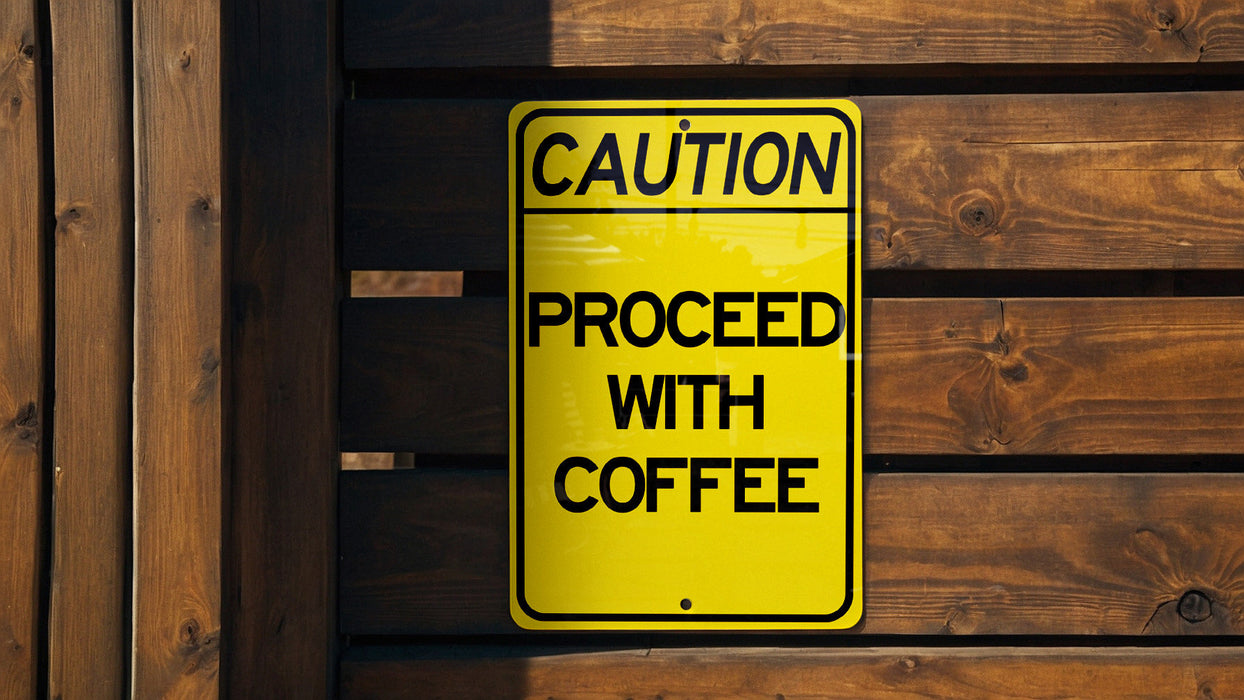 a caution sign posted on a wooden fence