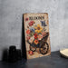 a wooden sign with flowers on it sitting on a table