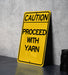 a yellow caution sign sitting on top of a table