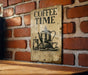 a coffee time sign on a brick wall