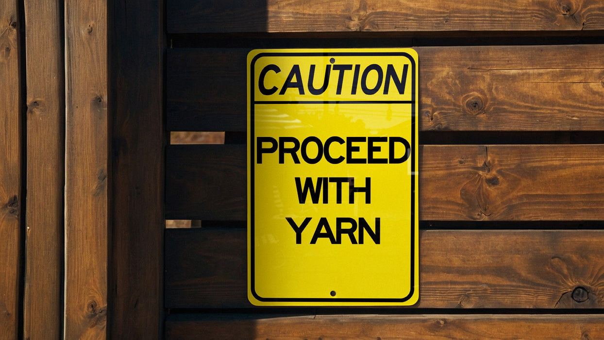 a caution sign posted on a wooden fence
